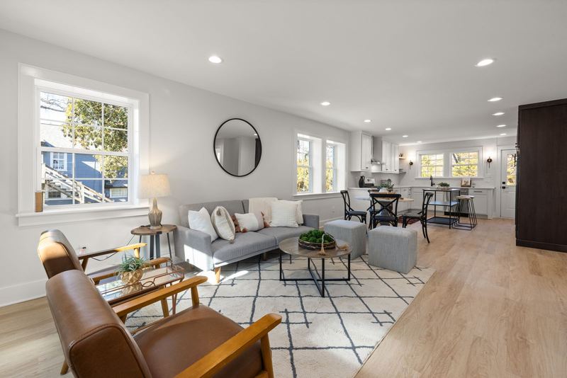 Bright, tidy living room with a grey sofa and wooden floor